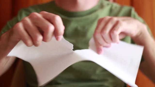 Man tearing a sheet of paper