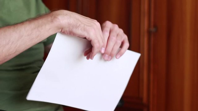 Man tearing a letter