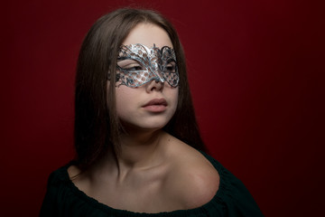 a girl in a Venetian mask