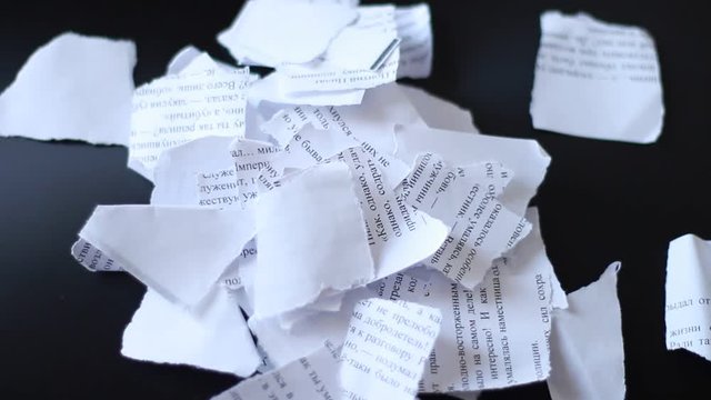 Teared pieces of paper on a table