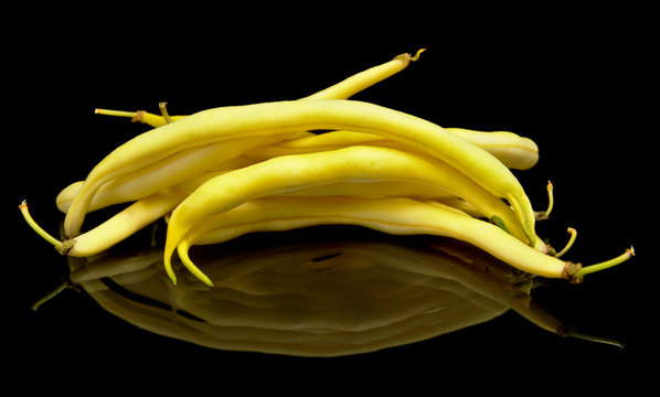Stack of yellow beans on black background