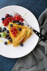crepes with fresh berry on white plate
