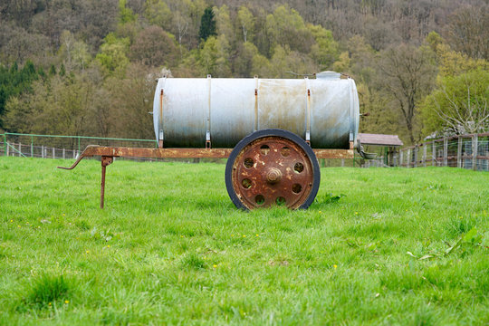 meadow with a cattle watering tank