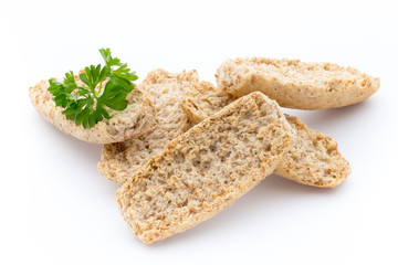 Dry flat bread crisps with herbs on a white background.