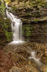 Obraz premium Waterfall Mosorny in Zawoja, Beskid Zywiecki mountain range in Polish Carpathian Mountains