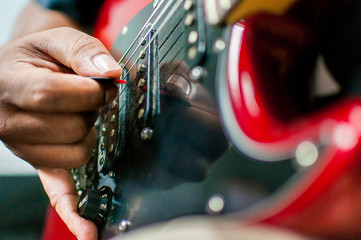 A man playing on the electric guitar