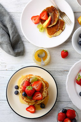 Pancakes with berries and honey