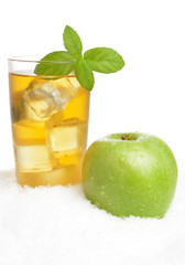 Apple juice,ice cubes with mint on white on snow