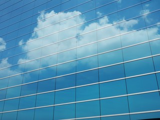 Clouds reflect in windows of modern building