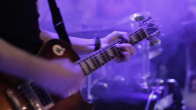 musician hand playing electric guitar