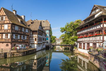 Fototapeta na wymiar Strasbourg, France. The picturesque landscape with reflection in the water of old buildings in the quarter 