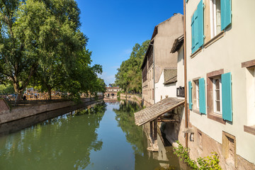 Fototapeta na wymiar Strasbourg, France. One of the Ile river flow in the quarter district of 