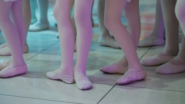 feet of young girls and boys dancing slippers