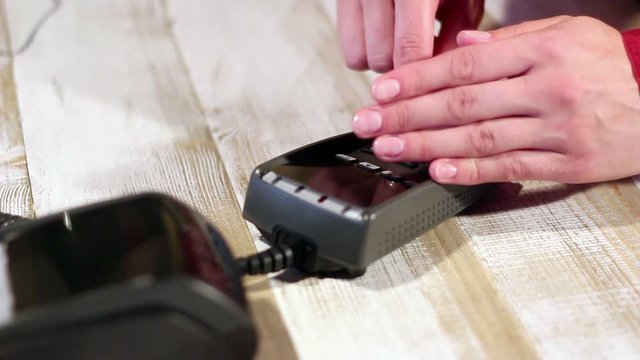 Hiding pin code with hand. Dialing pin code on pin pad of card machine