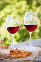 Wine, bread and wheat on the wooden table