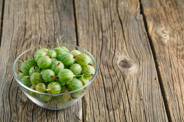 Green gooseberries in a glass bowl