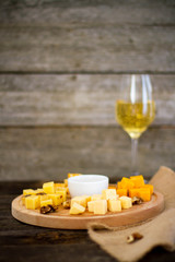 Cheese  and nuts on a wooden background

