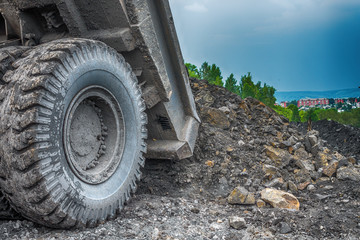 NOVOKUZNETSK, RUSSIA - JULY 26, 2016: Big yellow mining trucks and excavators at worksite
