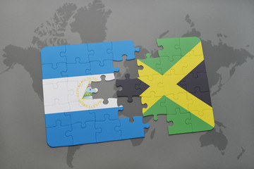 puzzle with the national flag of nicaragua and jamaica on a world map background.