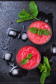 Watermelon red drink with mint on a grunge table