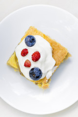 Apple pie cake with blueberries and wild strawberry with cream