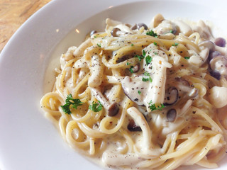 Mushroom cream sauce spaghetti on wooden table - top view