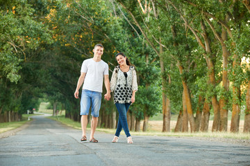 Fototapeta na wymiar happy young couple walk on country road outdoor, romantic people concept, summer season