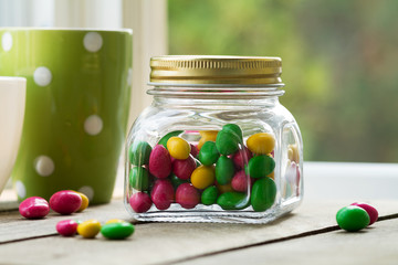 
colored dragees, candy in a glass jar