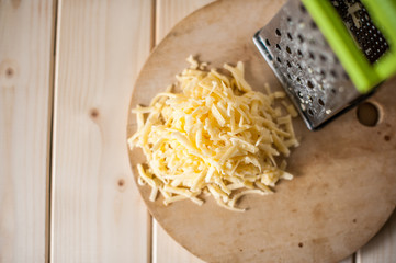 grated cheese on a wooden board