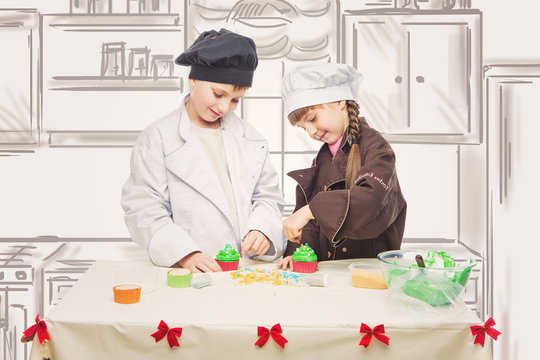 Children making christmas cupcakes
