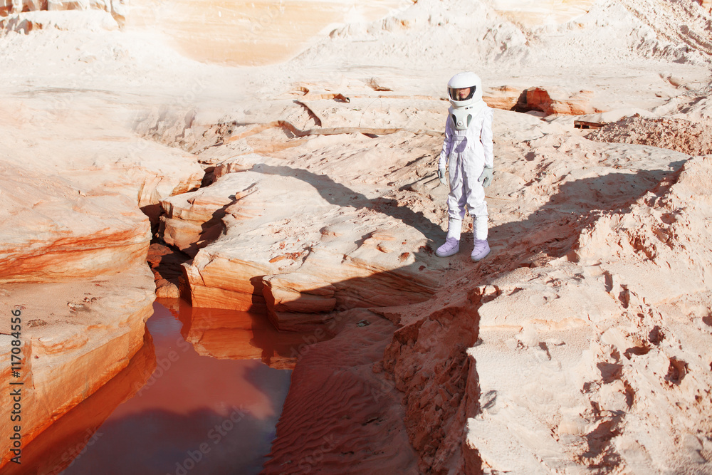 Wall mural futuristic astronaut on another planet, mars. image with the effect of toning