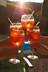 Cold summer drink by the pool. Party with refreshments by the pool. Alcohol drink with ice. Glasses with a refreshing drink. Alcohol at the party.
