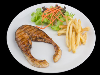 Salmon steak grilled isolated on the black background with clipping path