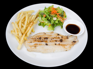 Fish fillet with french fries and salad isolated on the black background with clipping path