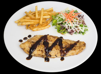 Fish fillet with french fries and salad isolated on the black background with clipping path