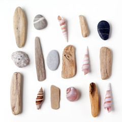 Pile of stones, sea shells flat lay closeup on white background. Tourism and travel holiday theme