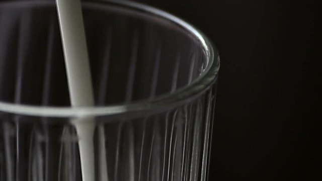 Pouring kefir into a glass