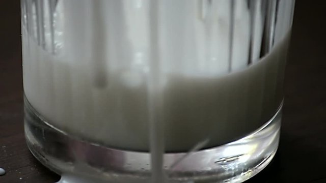 Pouring kefir into a glass