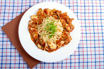 Top view on a plate of spaghetti with stewed meat