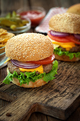 Cheeseburgers on wooden table with copy space 