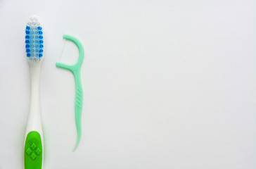 toothbrush and dental floss isolated on white background, copy space