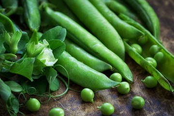 Ripe Green peas on wooden table - close up