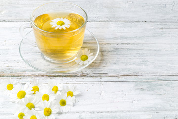 Chamomile tea on wooden background