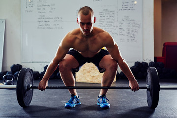 Concentrated athlete before power snatch exercise