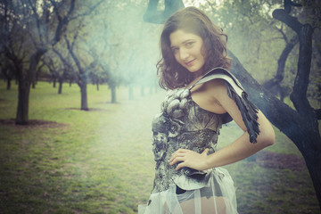 Natural, angel brunette woman with iron armor and black wings in