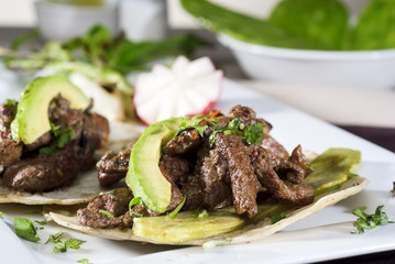 Mexican taco gourmet accompanied by avocado