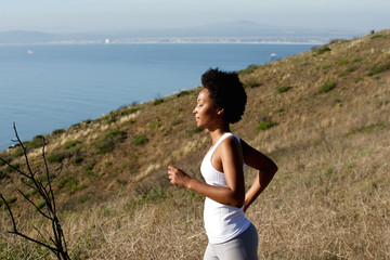 Healthy young woman running on mountains