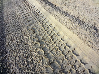 SUV wheel trace on the desert road after the rain in the Western Kazakhstan