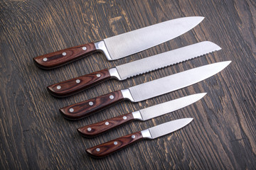  kitchen knifes on  board