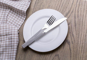 Empty plate, knife, fork and towel